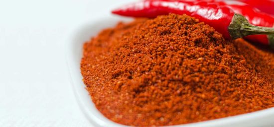 A vibrant pile of organic cayenne pepper powder